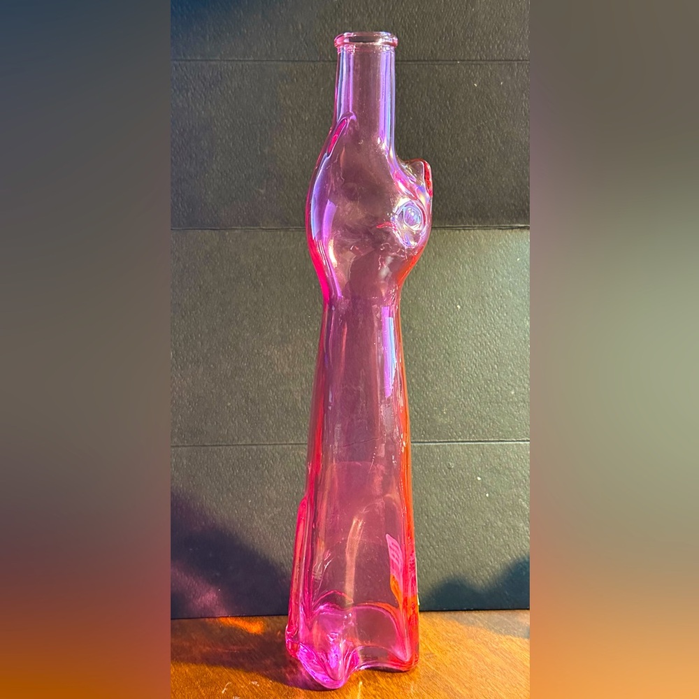 Clear pink glass cat shape empty wine bottle.